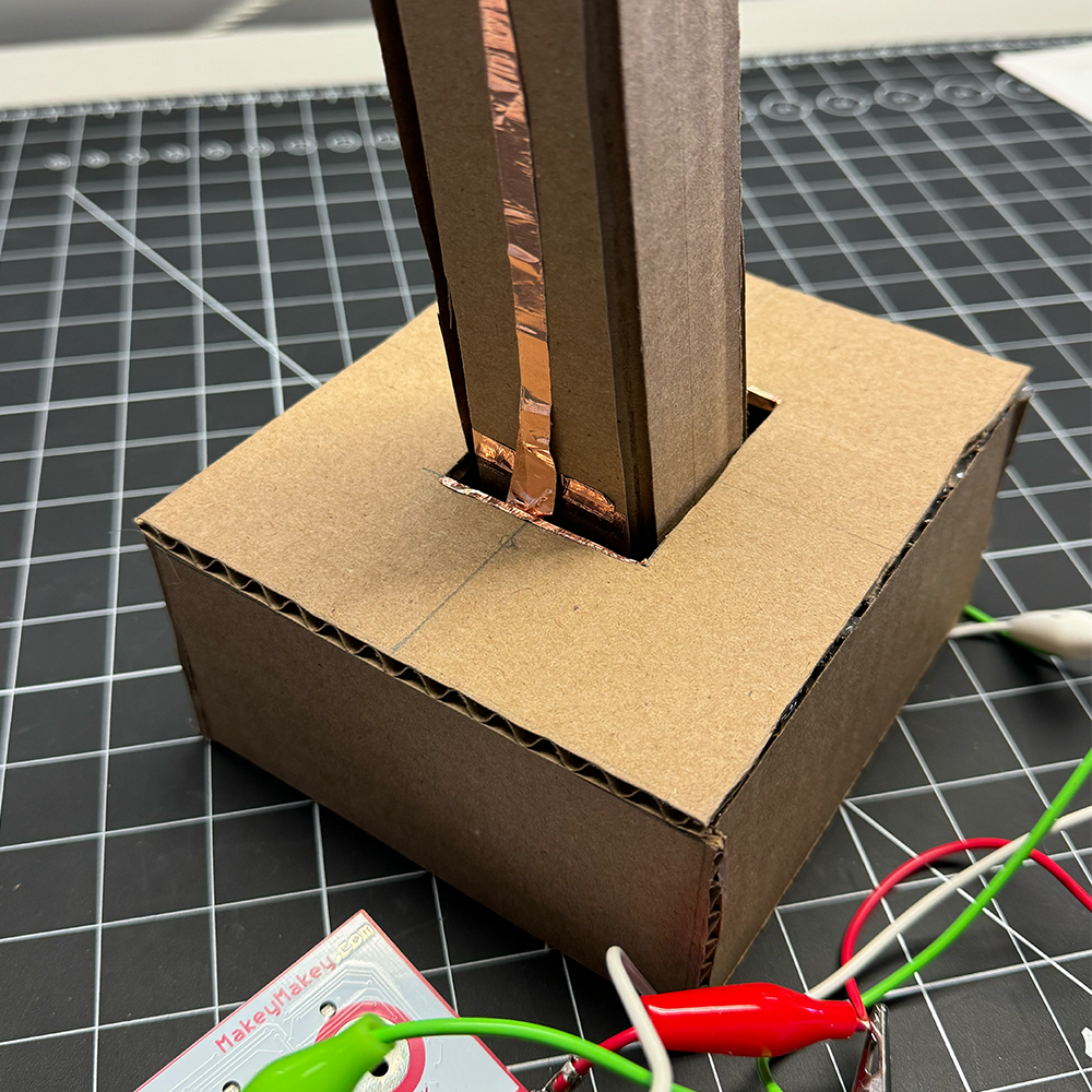 This is a close up image of my first prototype for my joystick. This image in particular shows how the circuit would close by having the copper tape touch the aligator clips and the rim of the opening. 