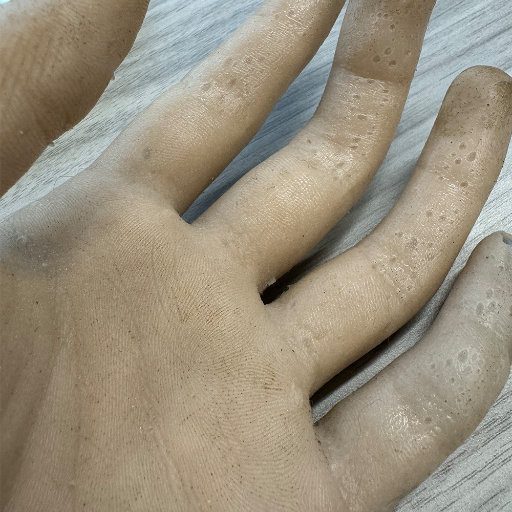 This is a hand made of silicone or some sort of rubber was that poured into a mold.